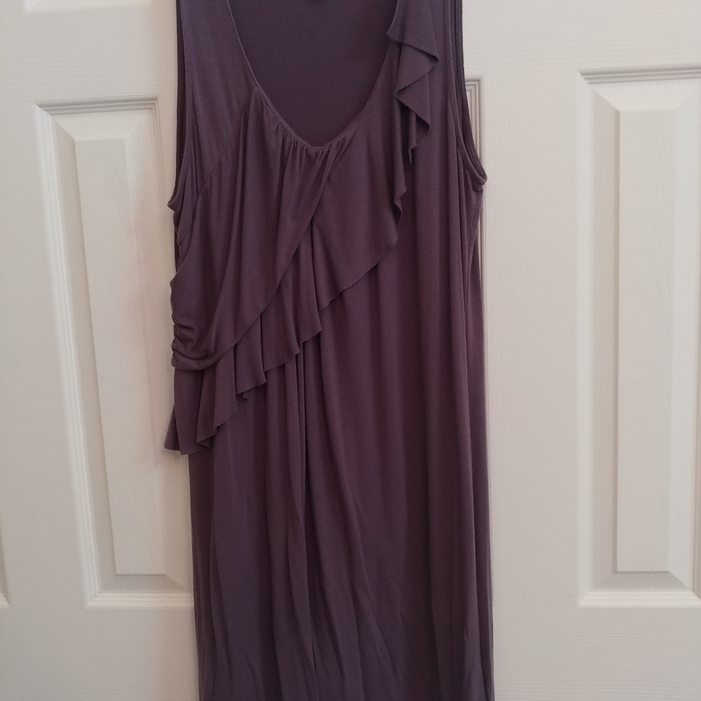 Sleeveless dark gray ruffle dress.